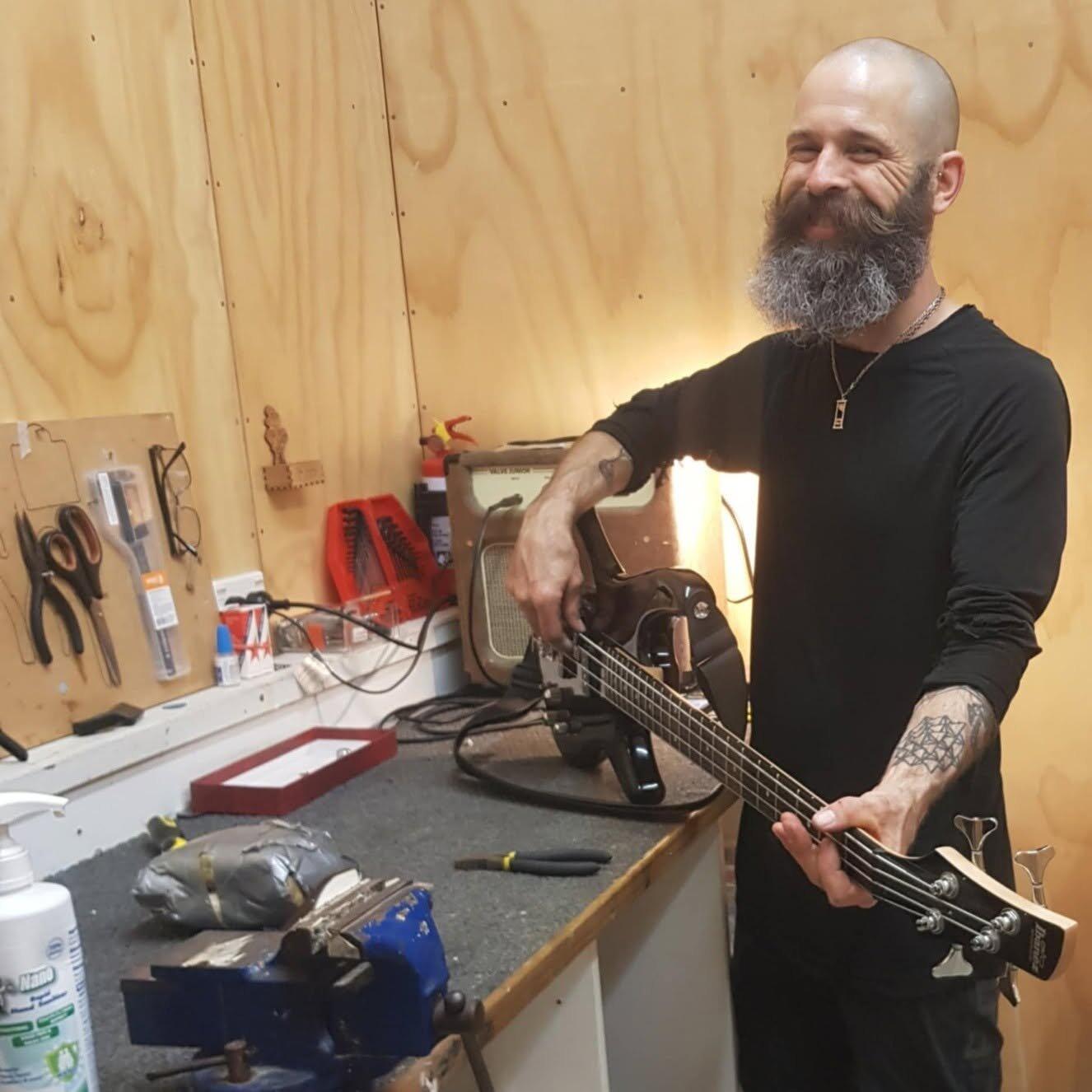 Benjamin Jackson restringing a guitar